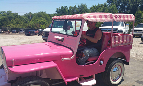 owner of L&S Automotive Service in a pink jeep outside